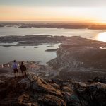 TwohikersoverlookingNuukinthemidnightsunfromthepeakofUkkusissaq-StoreMaleneinGreenland